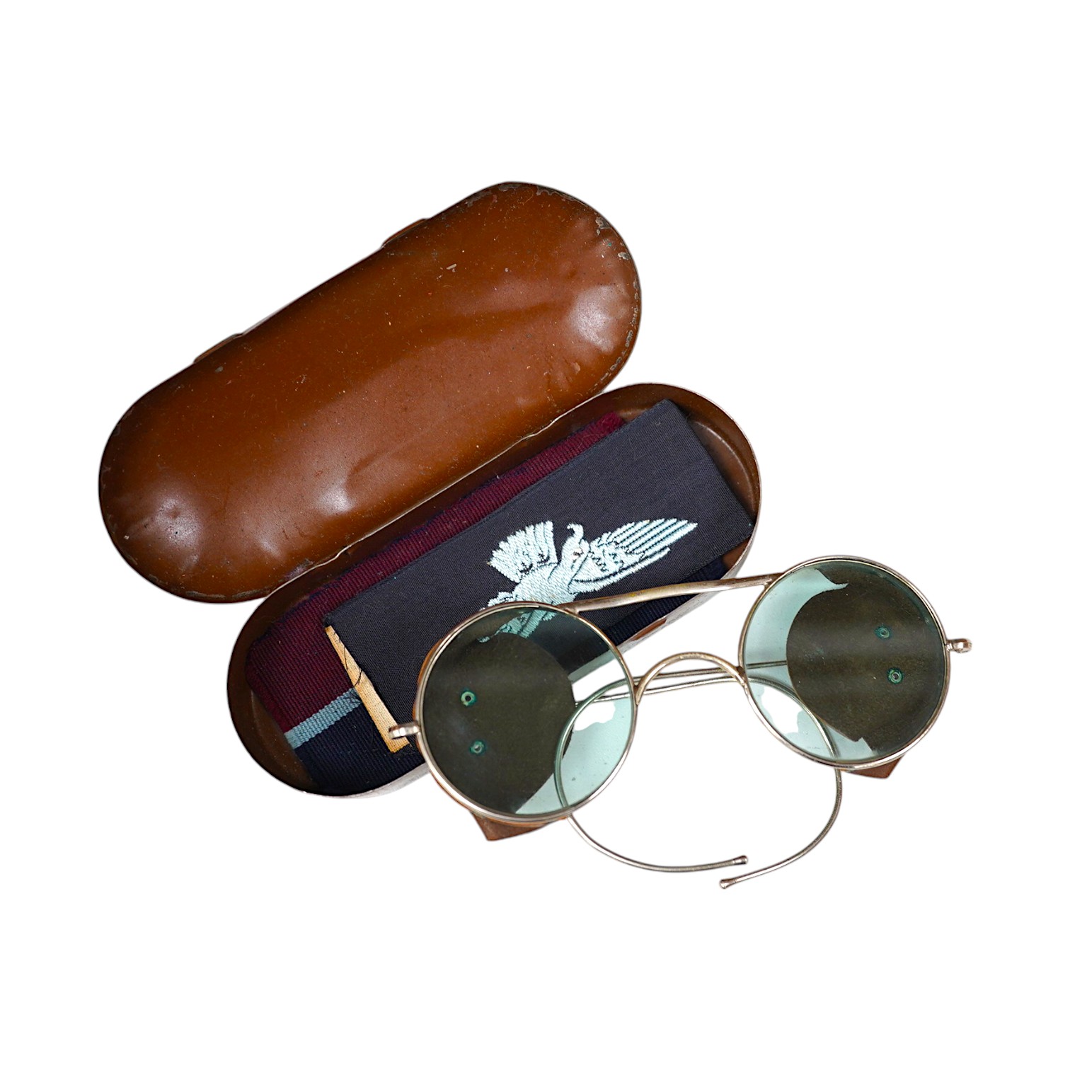 A cased pair of Air Ministry issue tinted glass spectacles with leather side attachments, case stamped; AM 294/11/P.1293, with sundry cloth badges. Condition - fair to good